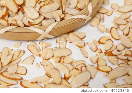 Closeup of sliced amonds on a white background 44325846