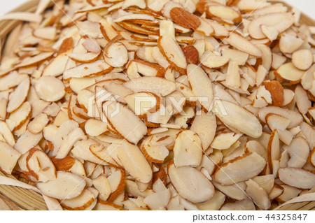 Closeup of sliced amonds on a white background 44325847
