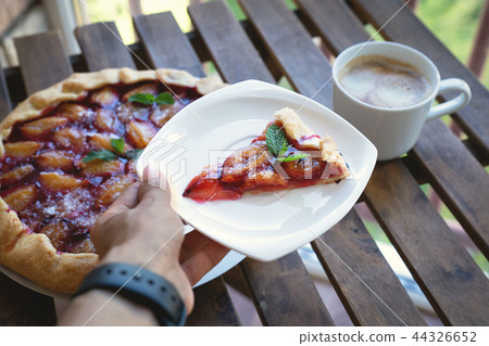 Plum tart with cinnamon. Portion of cake on a plate with shallow depth of field. Plum tart with cinnamon. Portion of cake on a plate with shallow depth of field. 44326652