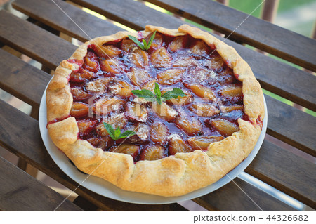 Plum tart with cinnamon. Portion of cake on a plate with shallow depth of field. 44326682