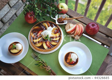 Apple tart with caramel on white plate 44326685