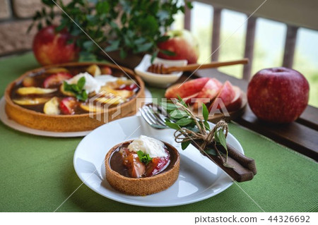 Apple tart with caramel on white plate 44326692