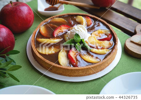 Apple tart with caramel on white plate 44326735