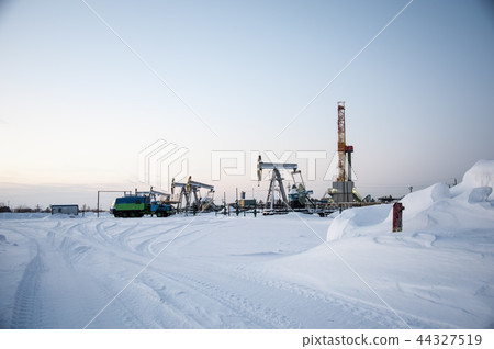 Oil field. Drilling rig and oil pump. Oil field. Drilling rig and oil pump. 44327519