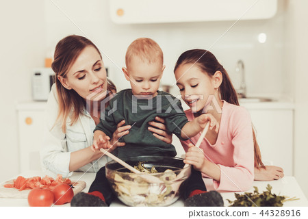 Happy Family Is Preparing A Salad At Kitchen. Happy Family Is Preparing A Salad At Kitchen. 44328916