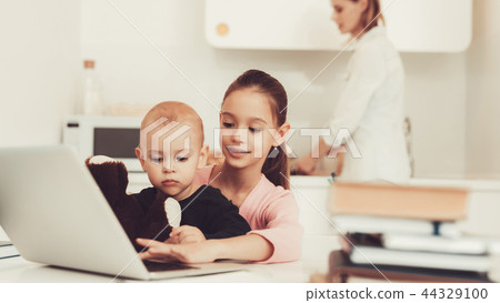 Young Girl Plays With Baby Brother On Kitchen. 44329100