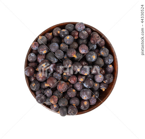 Dried juniper berries in wooden bowl 44330524