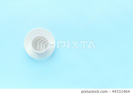 empty white coffee cup and dish saucer on blue  44331464