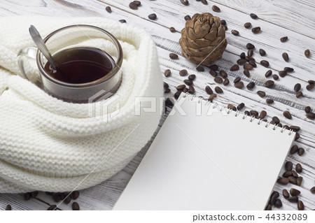 Tea, scarf, pine nuts, notebook, wooden background 44332089