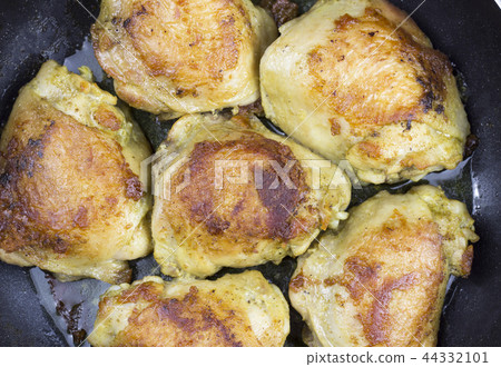 Fatty, fried chicken thighs, close-up Fatty, fried chicken thighs, close-up 44332101