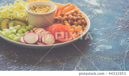 Healthy cut vegetables on the blue table Healthy cut vegetables on the blue table 44332953