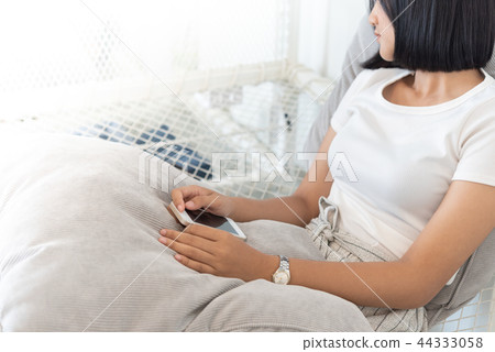 Asian girl sleeping and hands holding a mobile 44333058