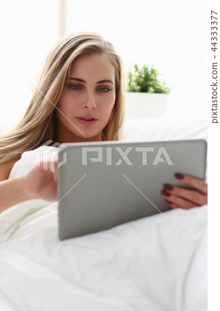 woman work winh laptop stay in bed early morning 44333377