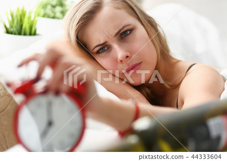 young woman wake up in the morning after night party young woman wake up in the morning after night party 44333604