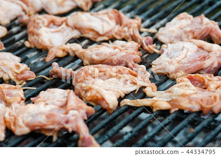 Chicken thighs and legs at barbeque grate Chicken thighs and legs at barbeque grate 44334795