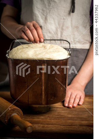 Female hand holds container with dough Female hand holds container with dough 44337962