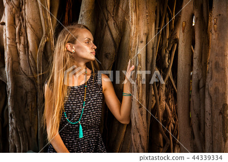 Young girl under the banyan tree 44339334