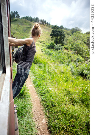 woman peeking out of a train woman peeking out of a train 44339358
