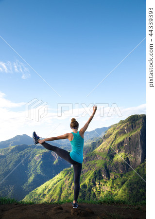 Girl doing yoga in the mountains Girl doing yoga in the mountains 44339393