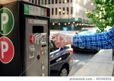 man is paying his parking using credit card man is paying his parking using credit card 44340858