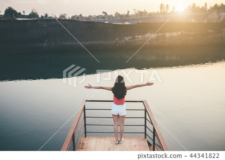 young girl enjoying sunset on the balcony young girl enjoying sunset on the balcony 44341822
