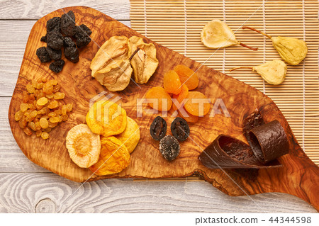Dried fruits on wooden background Dried fruits on wooden background 44344598