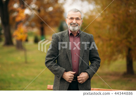 A nice grandfather with a beautiful beard wear a gray jacket 44344886