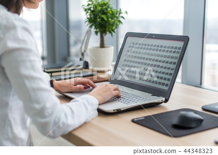 Working with laptop woman writing a blog. Female hands on the keyboard. 44348323