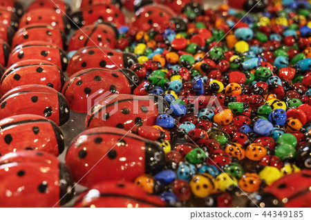 Texture of multicolored glass small  big ladybugs 44349185