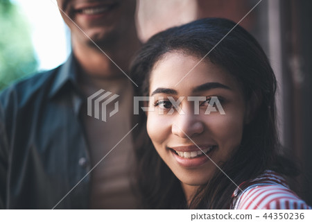 Expressive young woman smiling while looking at you 44350236