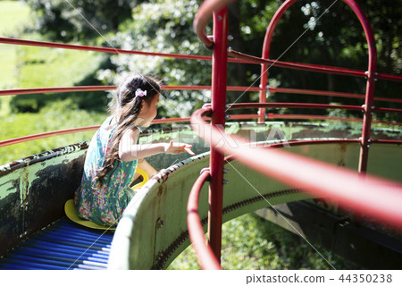 Girl playing on the slide Girl playing on the slide 44350238