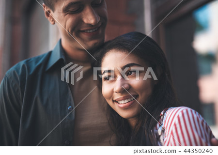Peaceful woman leaning to her boyfriend and smiling 44350240