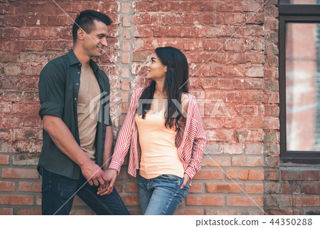 Romantic couple is communicating outdoors and smiling Romantic couple is communicating outdoors and smiling 44350288