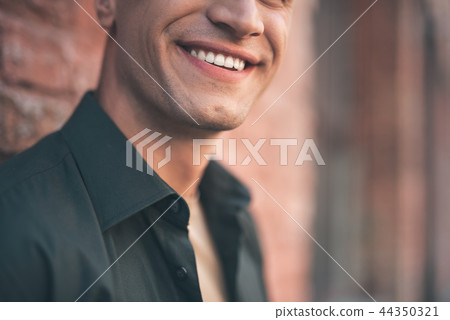 Close up of male smile with teeth revealed Close up of male smile with teeth revealed 44350321