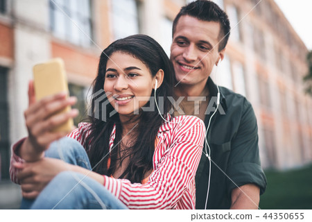 Loving couple listening to music and looking at the screen 44350655