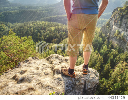 Hiker man stays on the mountain hill during hiking 44351429