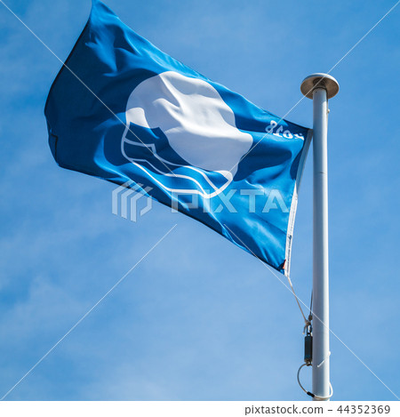 Blue Flag beach, flag over cloudy sky Blue Flag beach, flag over cloudy sky 44352369