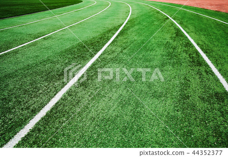 Running track with bright green artificial turf Running track with bright green artificial turf 44352377