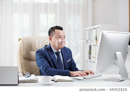 Businessman working on computer Businessman working on computer 44352828