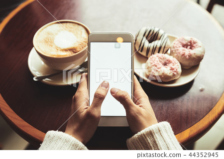 Enjoying coffee and texting Enjoying coffee and texting 44352945