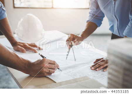 Hands of architect or engineer working on blueprint meeting for Hands of architect or engineer working on blueprint meeting for 44353185