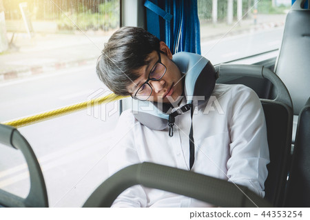 Young Asian man traveler sitting on a bus and sleeping with pill