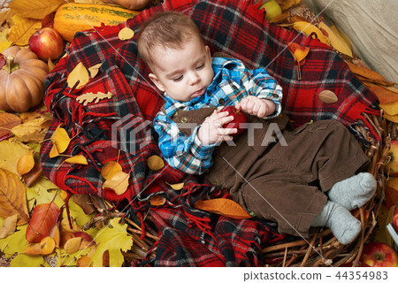 autumn concept - child boy lie on yellow leaves  44354983