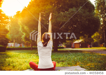 girl doing yoga outdoors girl doing yoga outdoors 44358458