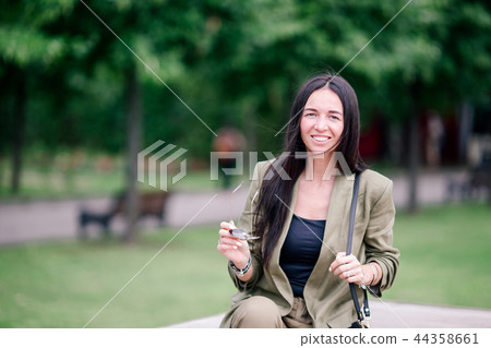 Portrait of young attractive tourist woman outdoors 44358661