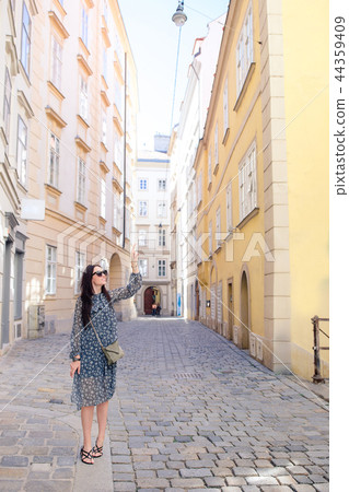 Woman walking in city. Young attractive tourist outdoors in european city Woman walking in city. Young attractive tourist outdoors in european city 44359409