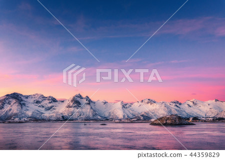Mountains and colorful sky reflected in water Mountains and colorful sky reflected in water 44359829
