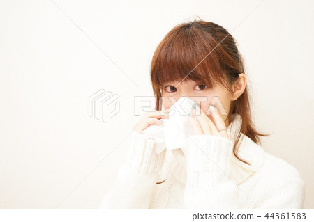 Young Japanese woman blowing nose with tissue Young Japanese woman blowing nose with tissue 44361583
