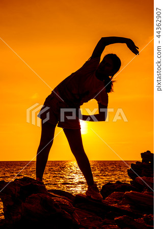 Silhouette woman yoga on the mountain sunset. Silhouette woman yoga on the mountain sunset. 44362907