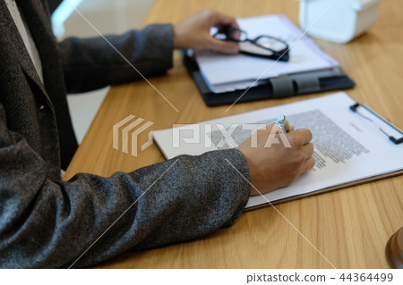 businesswoman read contract. woman considering mortgage loan document. 44364499